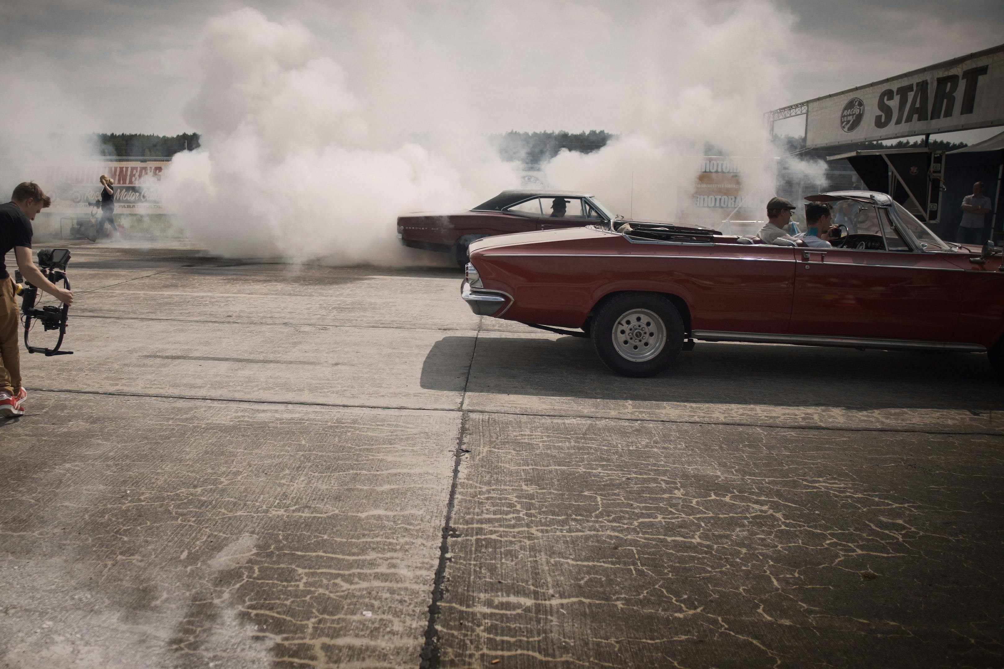 Old cars doing burnouts